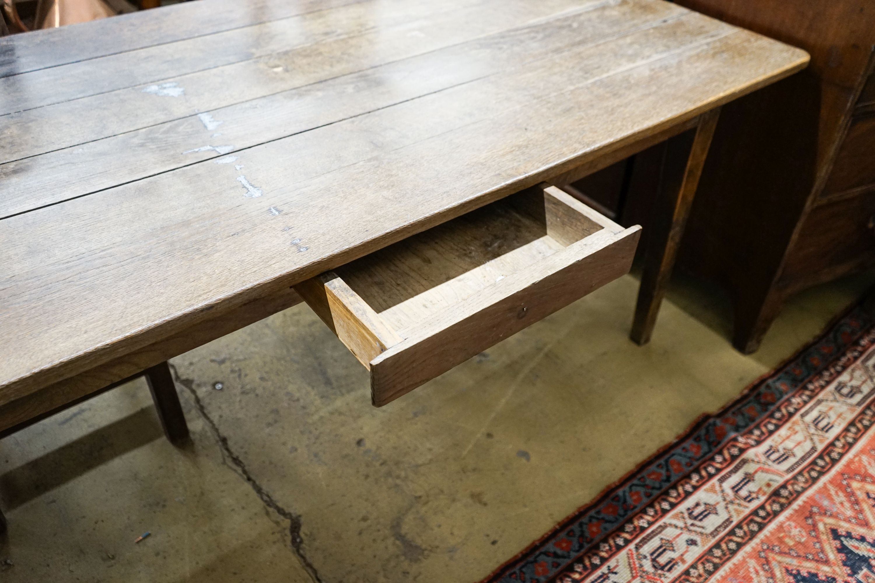 An early 19th century French provincial oak farmhouse table, fitted drawer, length 175cm, depth 86cm, height 73cm